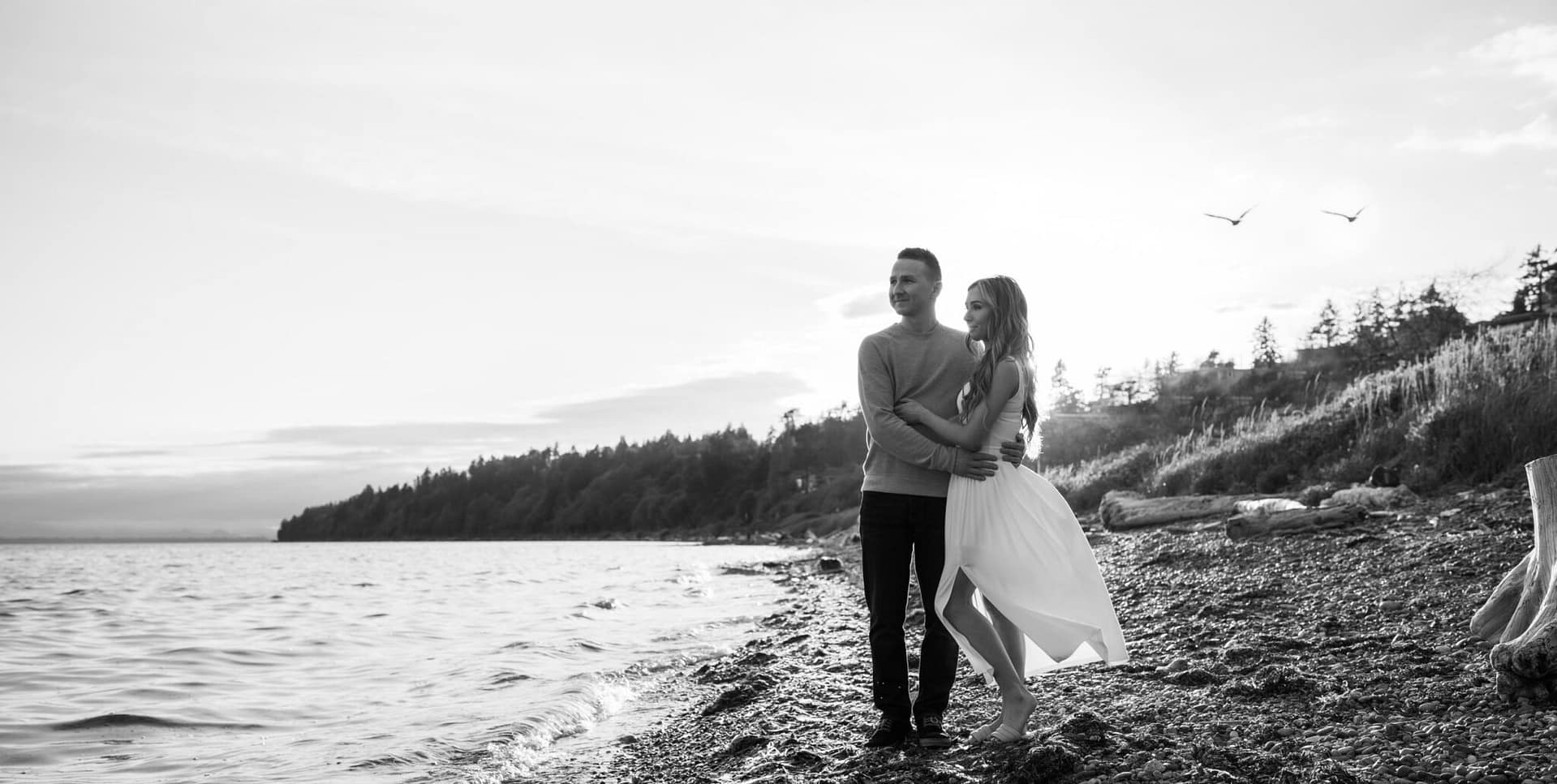 Couple enjoying view at the beach. Black and white photo