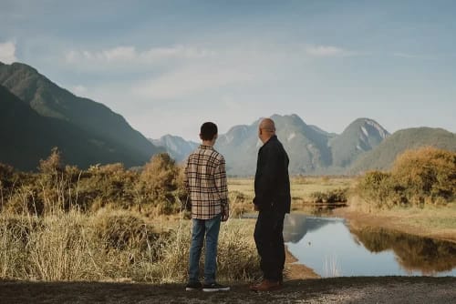 Man and son looking at mountains