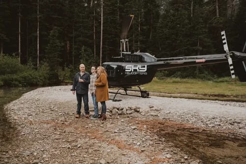 Family talking in front of helicopter